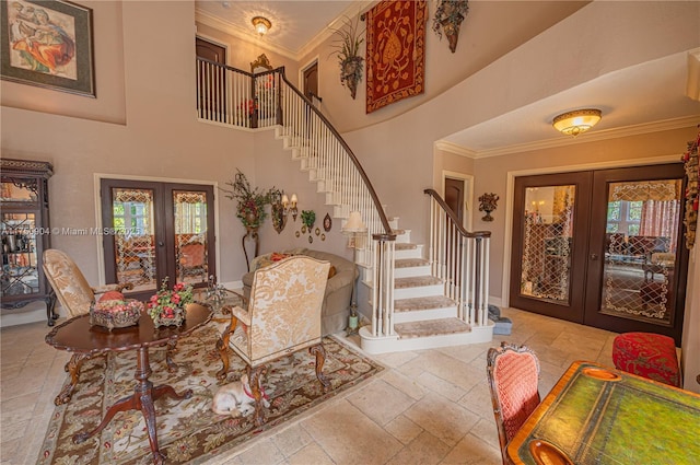 1111 Washington St, Hollywood, FL 33019 - foyer featuring stone tile floors, a towering ceiling, stairway, ornamental molding, and french doors
