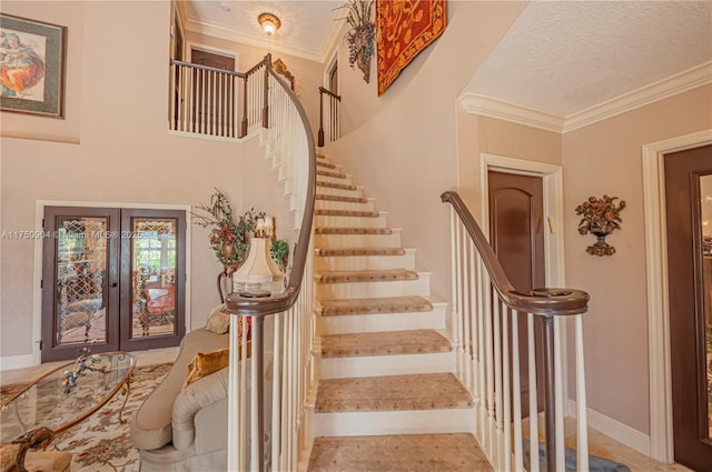 1111 Washington St, Hollywood, FL 33019 - stairs with ornamental molding, a textured ceiling, and french doors