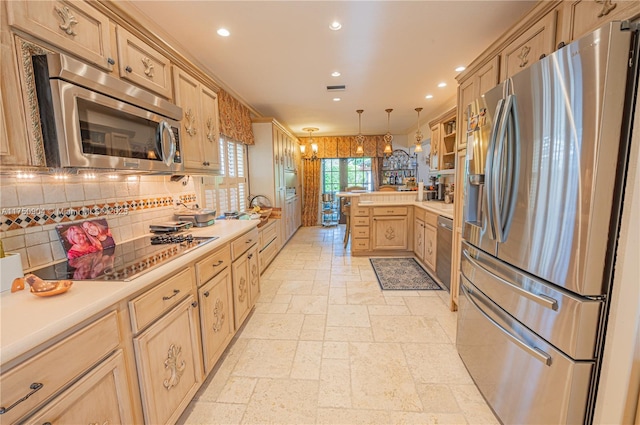 1111 Washington St, Hollywood, FL 33019 - kitchen with glass insert cabinets, a peninsula, stainless steel appliances, light countertops, and pendant lighting