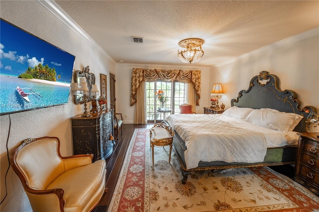 1111 Washington St, Hollywood, FL 33019 - bedroom featuring a textured ceiling, wood finished floors, visible vents, and crown molding