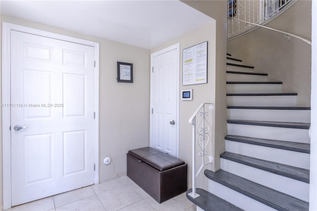 stairs featuring tile patterned floors