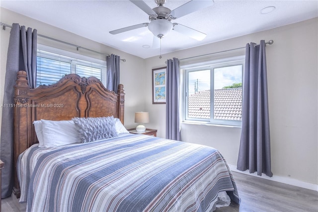 bedroom featuring a ceiling fan and wood finished floors