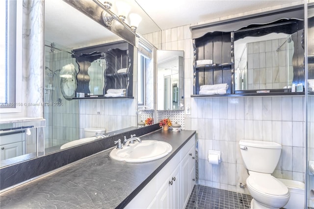 full bath featuring toilet, a shower with door, tile patterned floors, vanity, and tile walls