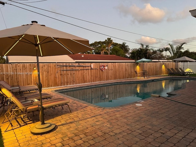 view of swimming pool with a fenced in pool, a fenced backyard, and a patio