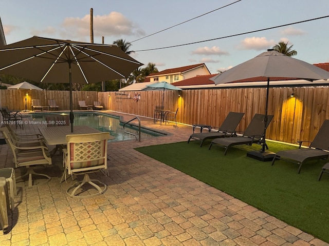 view of swimming pool featuring a fenced backyard, a fenced in pool, and a patio