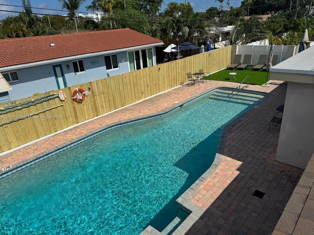 view of pool featuring a fenced in pool, a patio area, and a fenced backyard