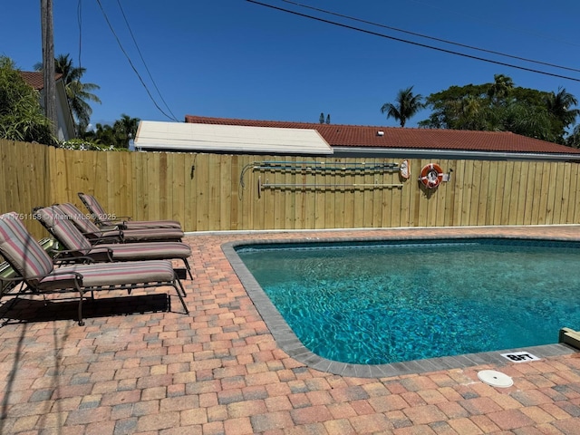 view of pool with a patio area, fence, and a fenced in pool