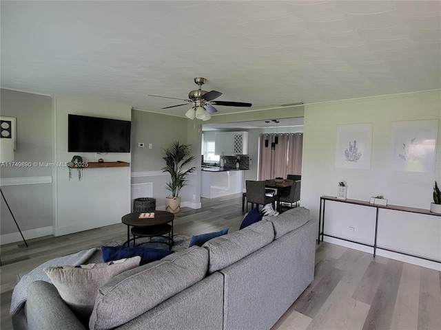 living area featuring ceiling fan and wood finished floors