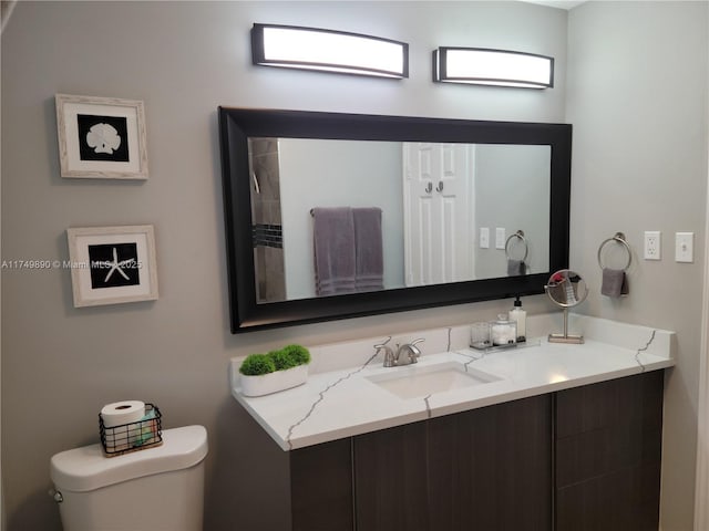 bathroom with toilet and vanity