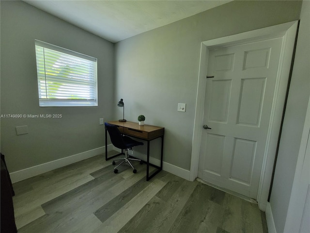 home office featuring baseboards and wood finished floors