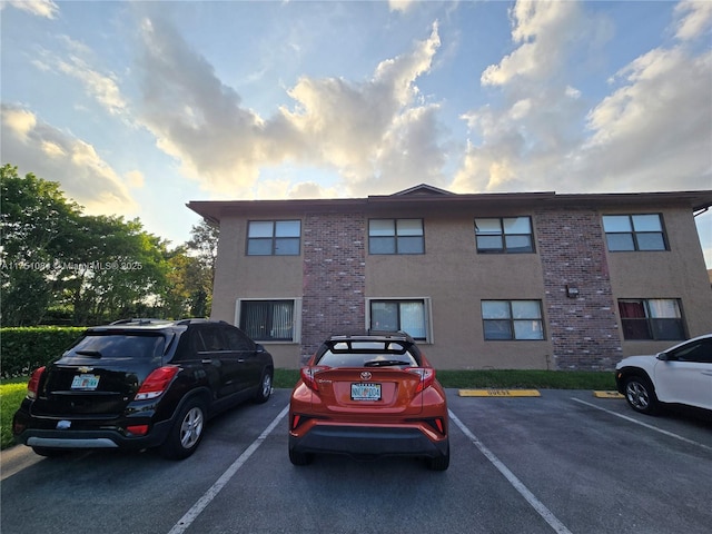 view of building exterior with uncovered parking