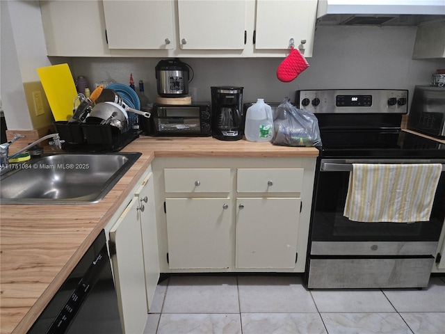 kitchen with white cabinets, stainless steel range with electric cooktop, a sink, and exhaust hood