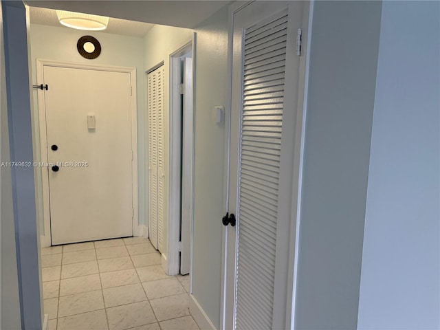 hallway with light tile patterned floors