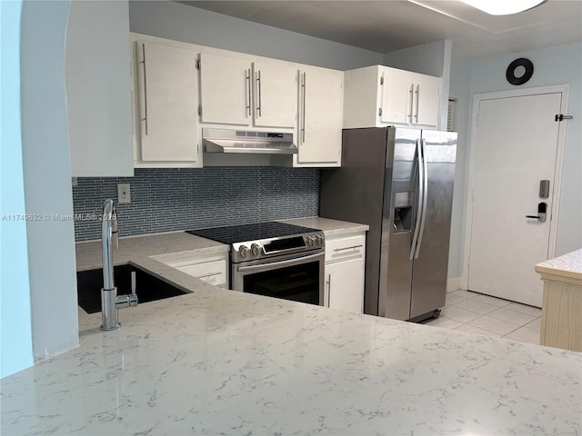 kitchen with light countertops, backsplash, appliances with stainless steel finishes, a sink, and under cabinet range hood