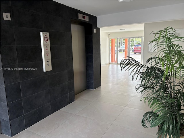 hall featuring light tile patterned flooring