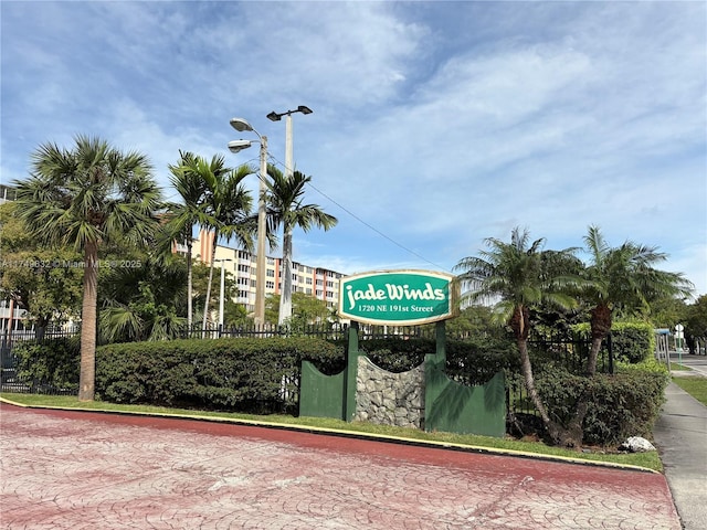 community sign featuring fence