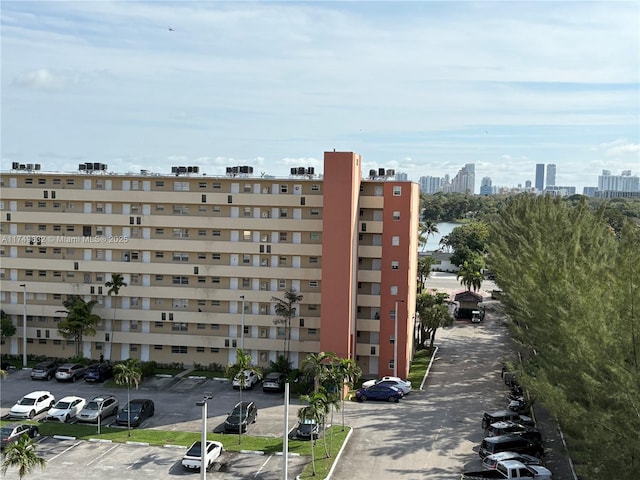 view of property featuring uncovered parking and a city view