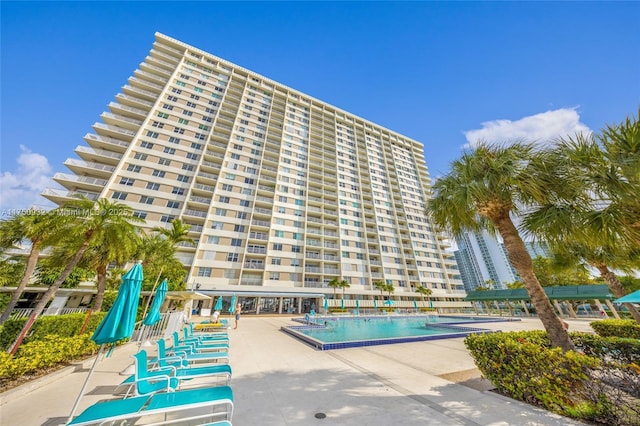 view of building exterior with a community pool