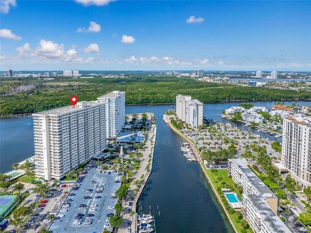 birds eye view of property with a water view and a city view