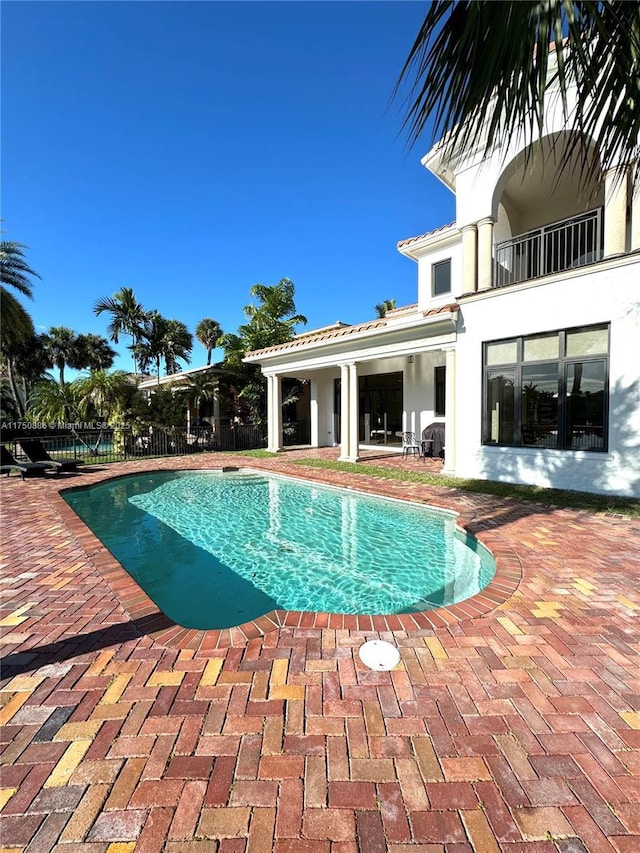 view of swimming pool with a fenced in pool, a patio, and fence