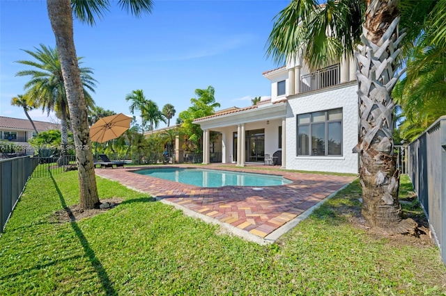 view of swimming pool with a fenced in pool, a patio area, a fenced backyard, and a yard