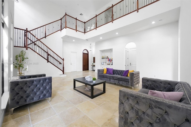8162 Canopy Ter, Parkland, FL 33076 - living area featuring arched walkways, a high ceiling, stairs, and recessed lighting