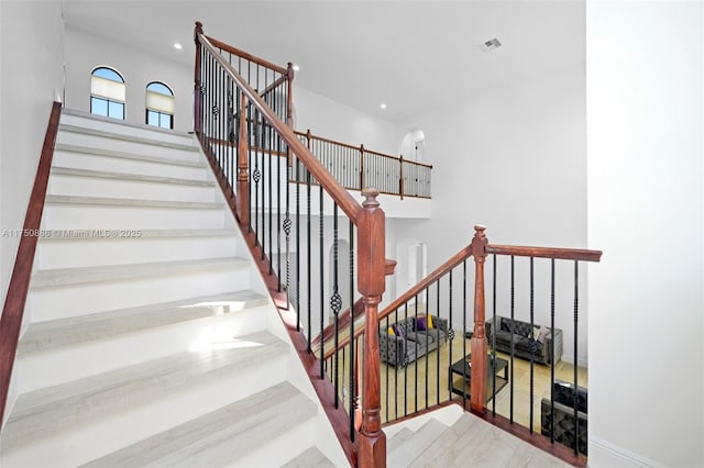 stairs with wood finished floors, visible vents, and recessed lighting