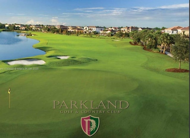 view of property's community with view of golf course, a water view, and a residential view