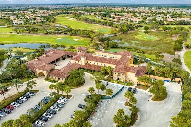 drone / aerial view featuring view of golf course and a water view