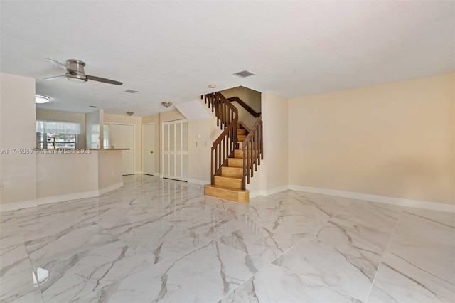 unfurnished room featuring marble finish floor, visible vents, baseboards, and stairs