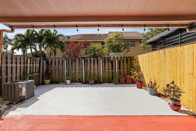 view of patio / terrace featuring a fenced backyard and central air condition unit