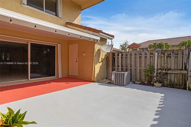 view of patio with fence and central AC