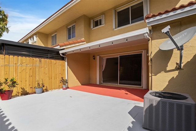 view of patio featuring fence and central air condition unit