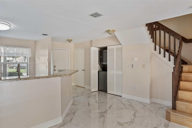 interior space with marble finish floor, visible vents, and baseboards