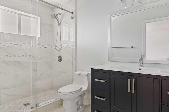 bathroom featuring toilet, a shower stall, and vanity