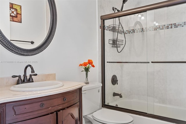 full bath with toilet, combined bath / shower with glass door, and vanity