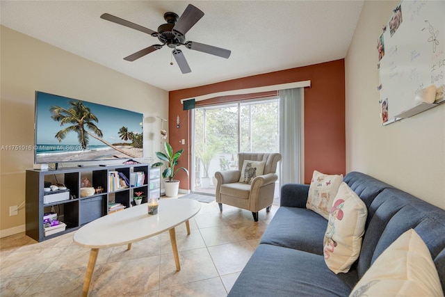 living room featuring baseboards, ceiling fan, and tile patterned floors