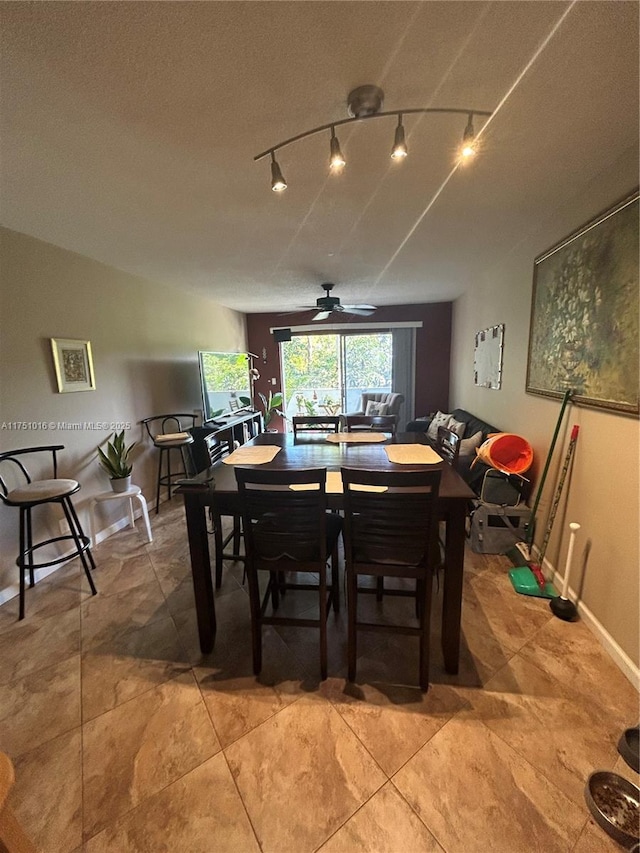 dining room featuring vaulted ceiling, a ceiling fan, and baseboards