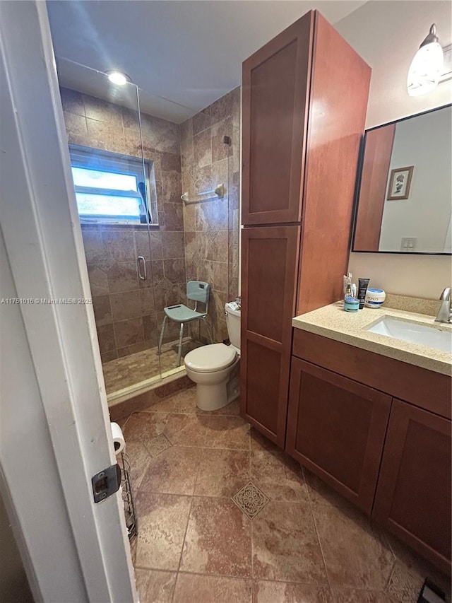 full bathroom with a stall shower, vanity, and toilet