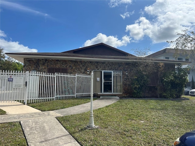 single story home with a fenced front yard and a front yard