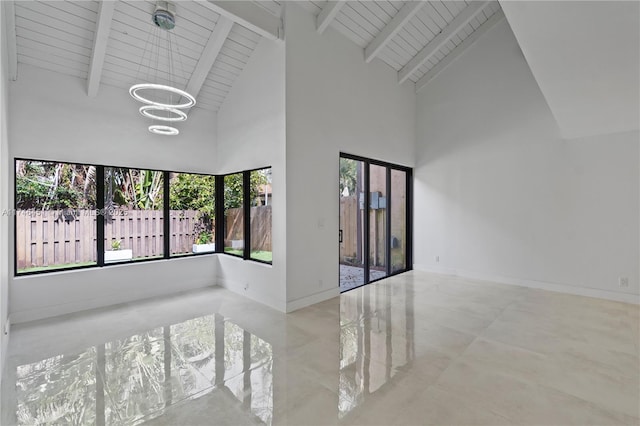 unfurnished room with beamed ceiling, baseboards, and an inviting chandelier