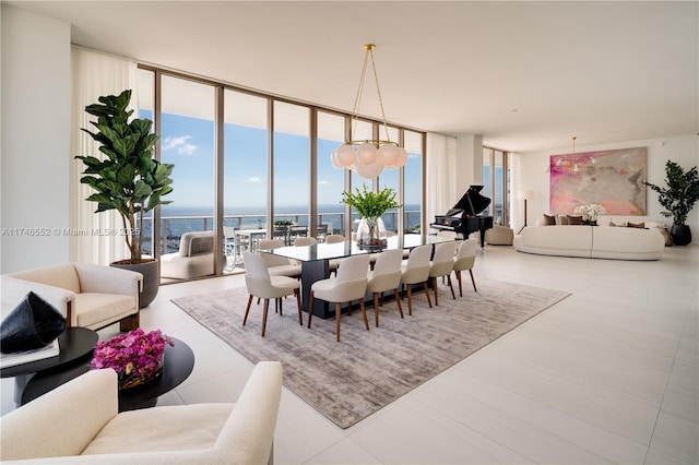 dining room with expansive windows, a healthy amount of sunlight, and a water view