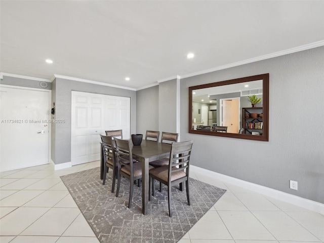 dining space featuring tile patterned flooring, crown molding, and baseboards