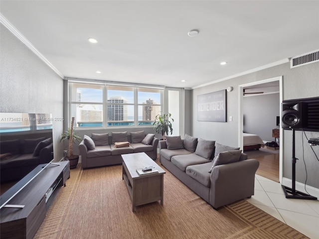 living room featuring tile patterned flooring, recessed lighting, visible vents, and ornamental molding