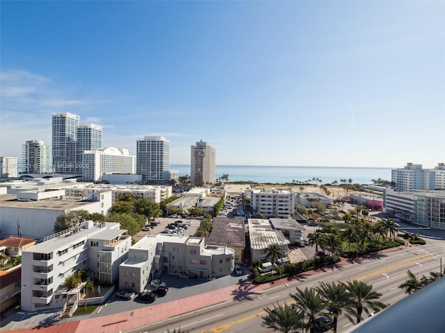 birds eye view of property with a city view and a water view