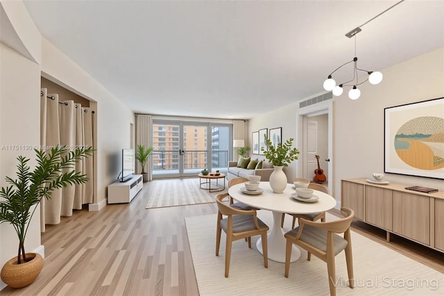 2751 S Ocean Dr Unit 1003N, Hollywood, FL 33019 - dining space featuring light wood-style floors and a chandelier