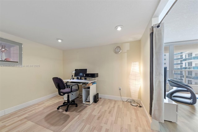 home office with wood finished floors and baseboards