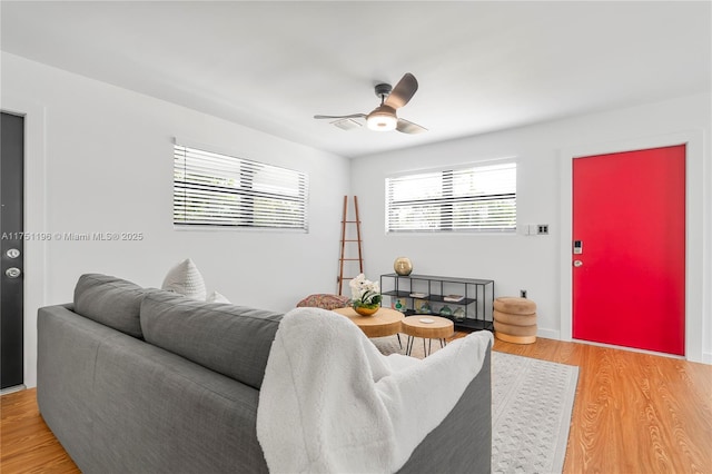 living room with a ceiling fan and wood finished floors