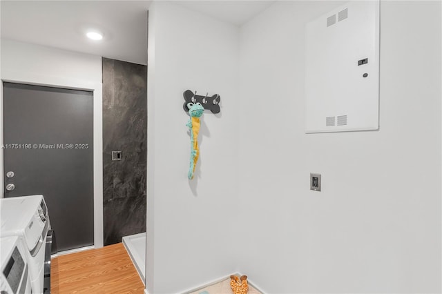 bathroom with washer and dryer and wood finished floors