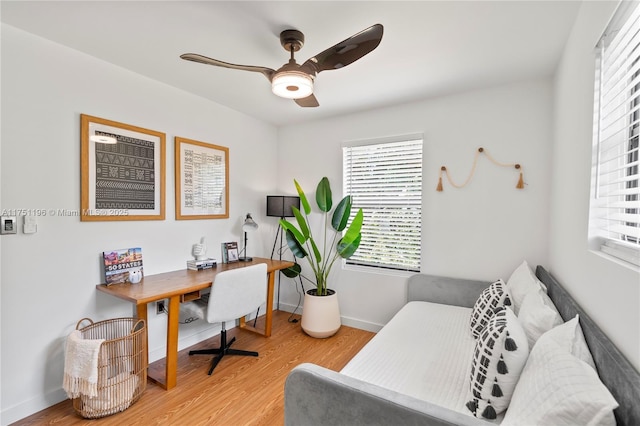 office space featuring wood finished floors, a ceiling fan, and baseboards